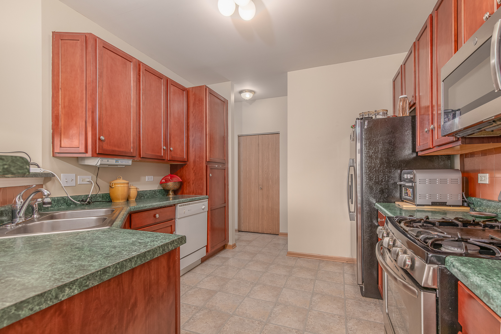 1902 Crestview Circle, Unit 1902 Romeoville, IL 60446 - Photo 13 of 32 a kitchen with stainless steel appliances granite countertop a stove a sink and a refrigerator