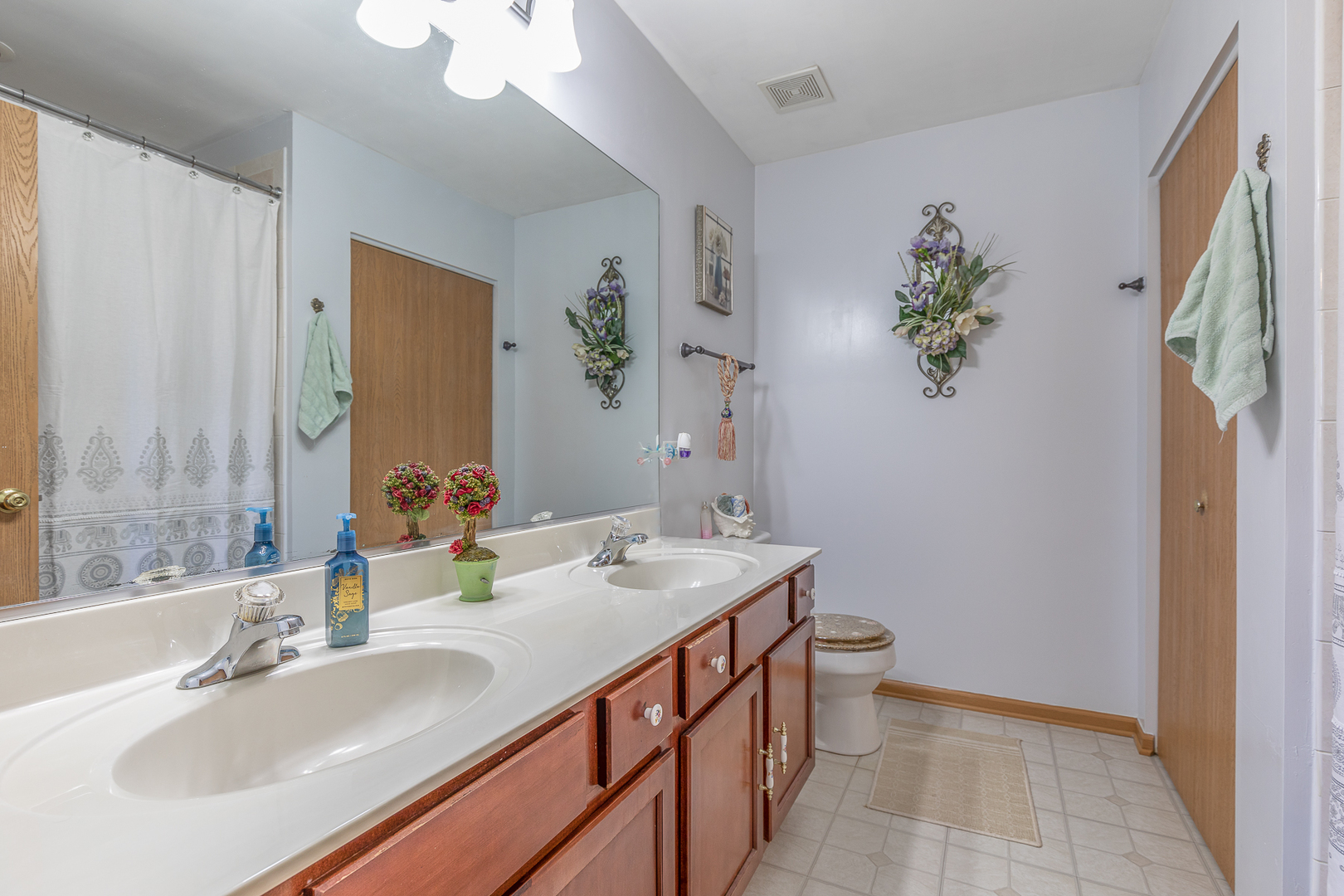 1902 Crestview Circle, Unit 1902 Romeoville, IL 60446 - Photo 21 of 32 a bathroom with a sink a toilet and a mirror