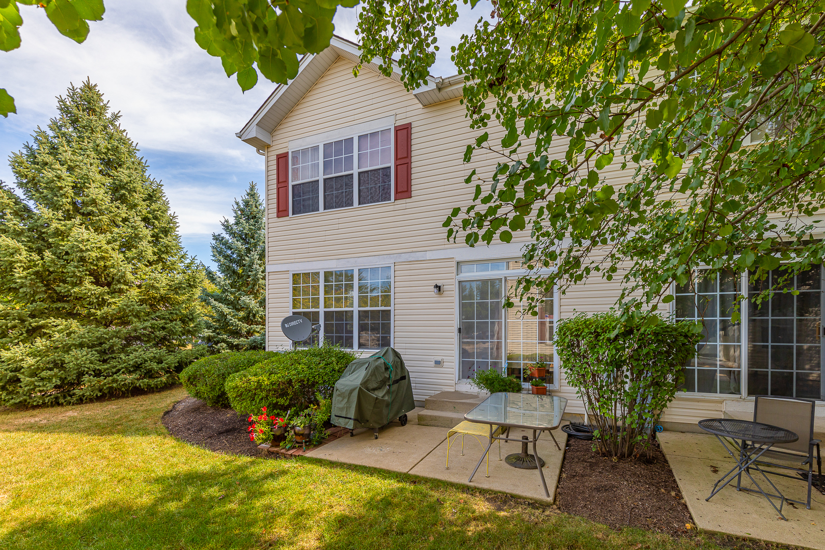 1902 Crestview Circle, Unit 1902 Romeoville, IL 60446 - Photo 5 of 32 a view of a house with backyard sitting area and garden