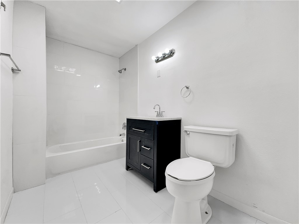 4115 Meridian Place Corpus Christi, TX 78411 - Photo 11 of 24 a bathroom with a sink a toilet and a bathtub