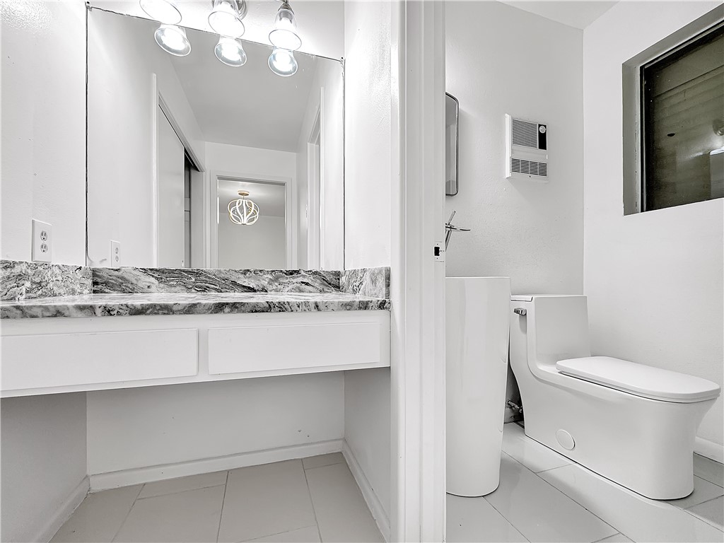 4115 Meridian Place Corpus Christi, TX 78411 - Photo 15 of 24 a bathroom with a sink a toilet and mirror