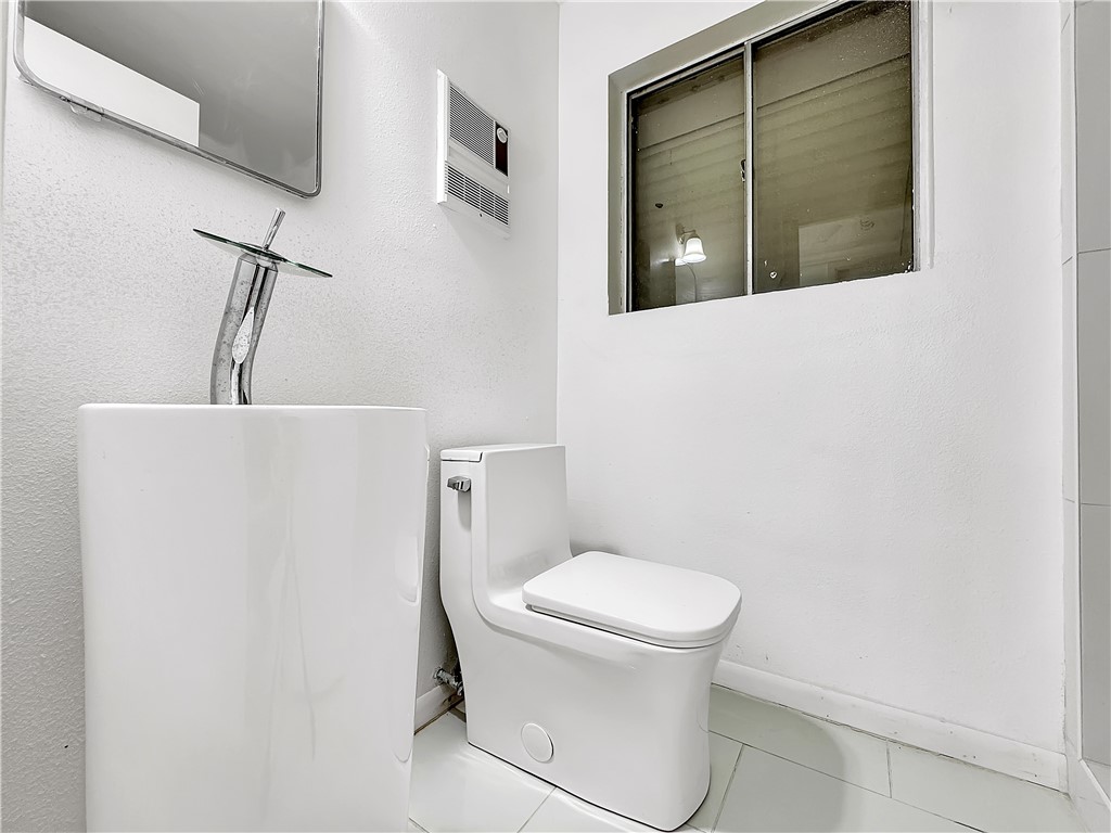4115 Meridian Place Corpus Christi, TX 78411 - Photo 16 of 24 a white toilet sitting next to a bathroom sink
