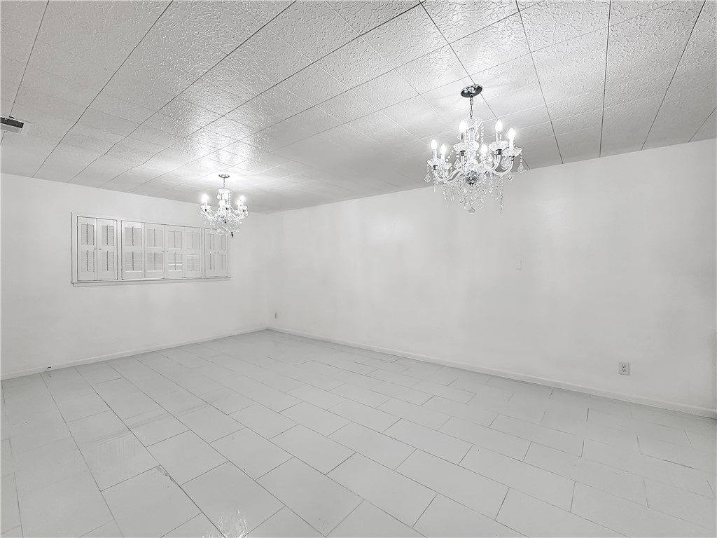 4115 Meridian Place Corpus Christi, TX 78411 - Photo 21 of 24 en empty room with chandelier