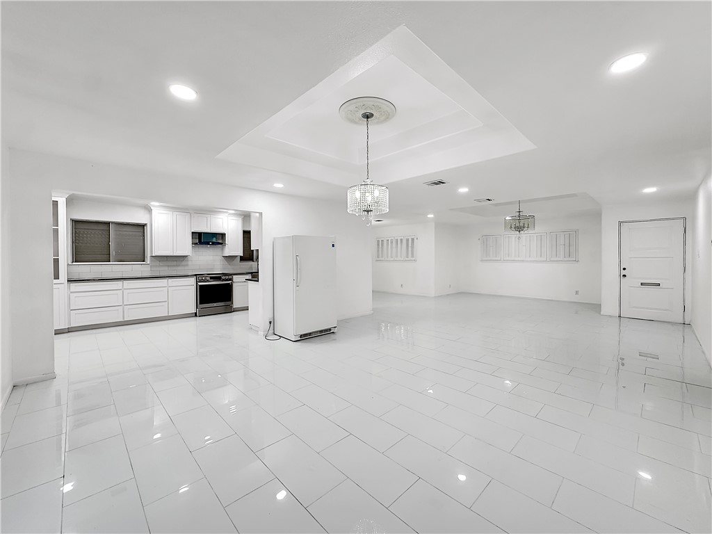 4115 Meridian Place Corpus Christi, TX 78411 - Photo 3 of 24 a large white kitchen with a stove a sink a refrigerator and a fireplace