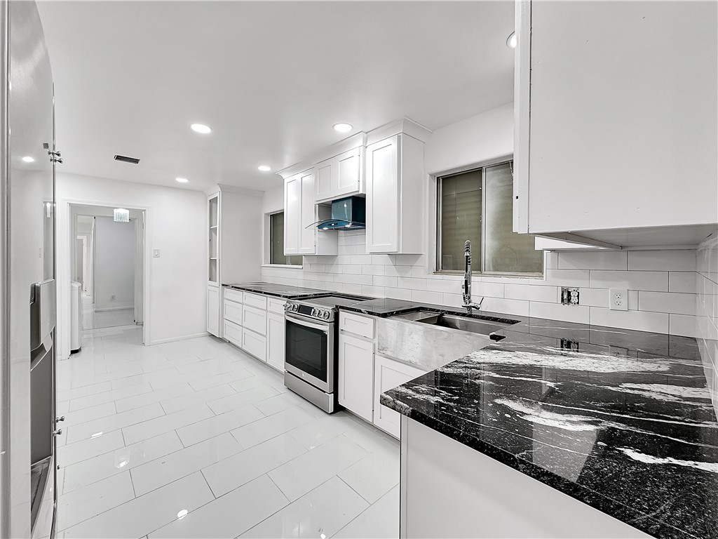 4115 Meridian Place Corpus Christi, TX 78411 - Photo 9 of 24 a kitchen with stainless steel appliances granite countertop a stove and a sink