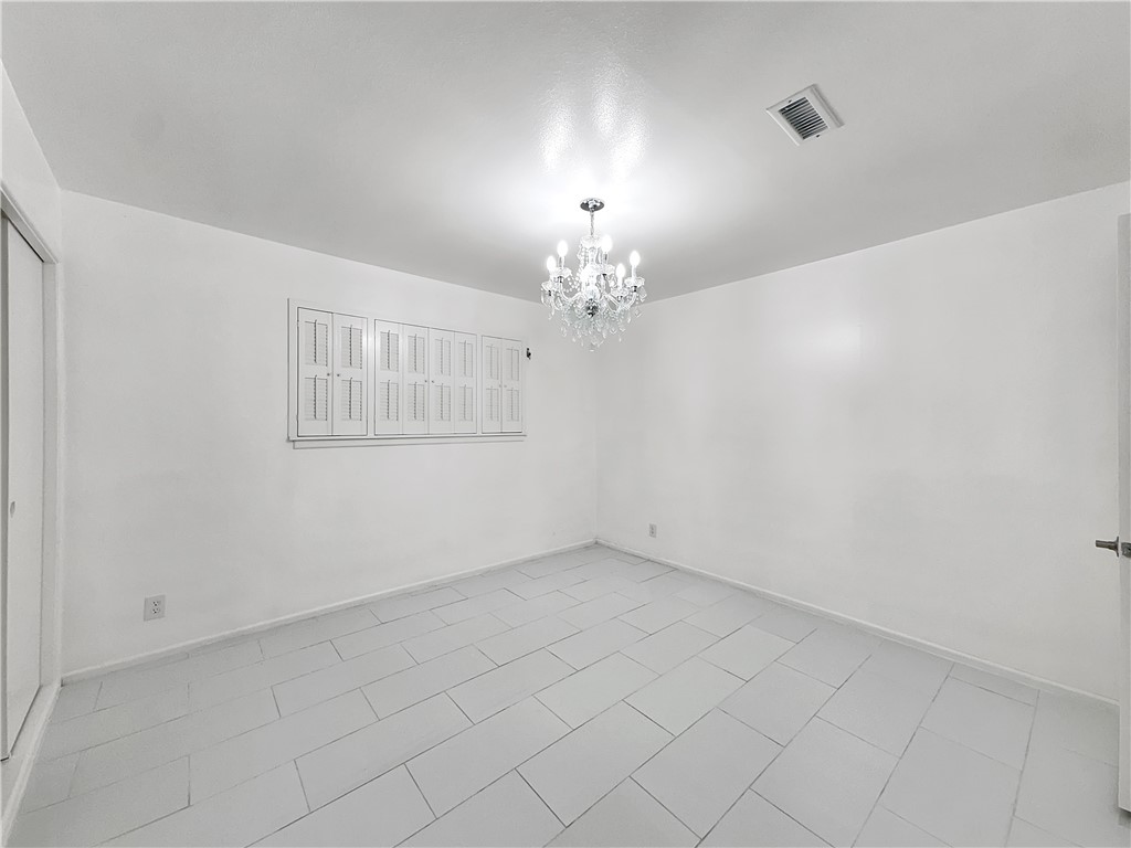 4115 Meridian Place Corpus Christi, TX 78411 - Photo 10 of 24 an empty room with chandelier fan and windows