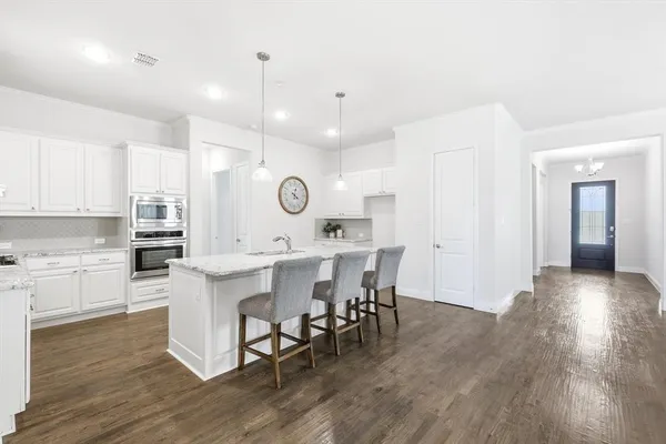 a view of kitchen with cabinets and wooden floor