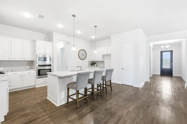 a view of kitchen with cabinets and wooden floor