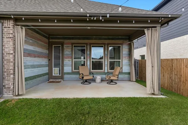 a front view of a house with a garden and sitting area
