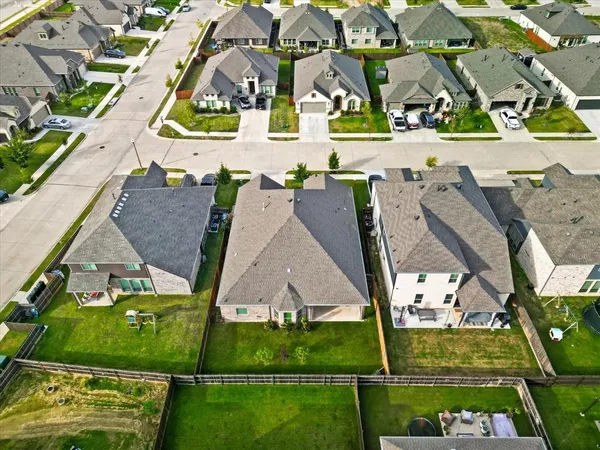 an aerial view of residential houses with outdoor space and street view