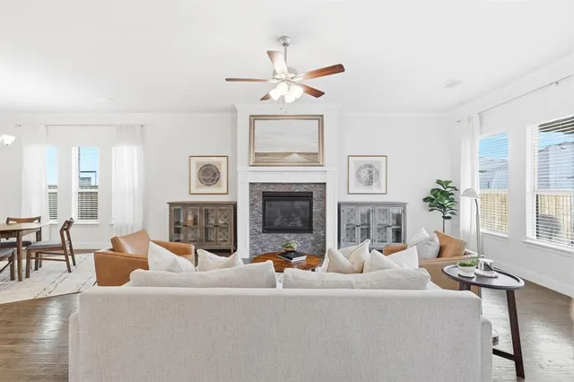 a living room with furniture a fireplace and a chandelier