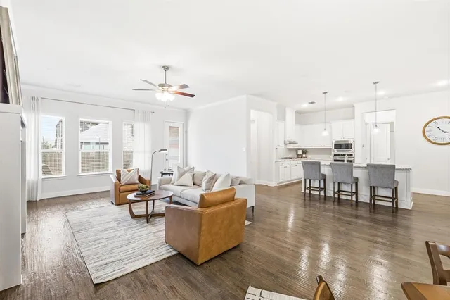 a living room with furniture and kitchen view