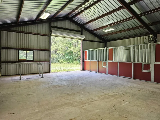 a view of an empty room with wooden fence