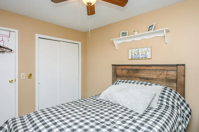 a bedroom with a bed and a painting on the wall