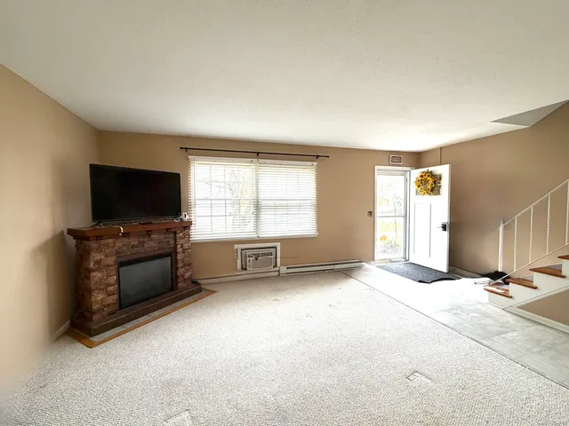 an empty room with windows and a flat screen tv