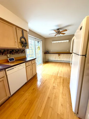 a kitchen with a sink and wooden floor