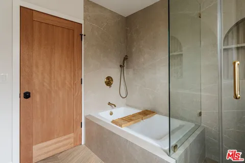 a bathroom with a glass shower door