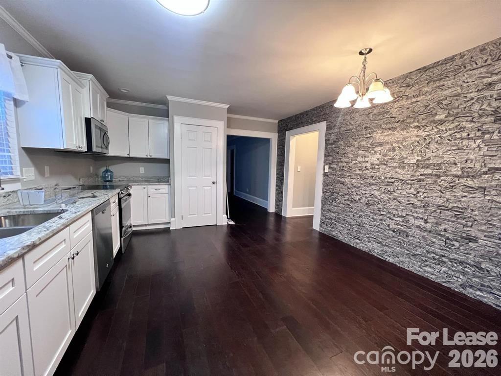 2104 Moose Road Kannapolis, NC 28083 - Photo 6 of 20 a kitchen with stainless steel appliances granite countertop a refrigerator and a stove top oven