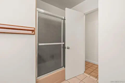 a bathroom with a glass shower door