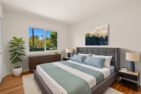 a bedroom with a bed and a potted plant