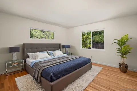 a bedroom with a bed and a potted plant