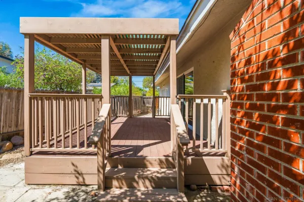 a view of a roof deck with wooden floor and fence