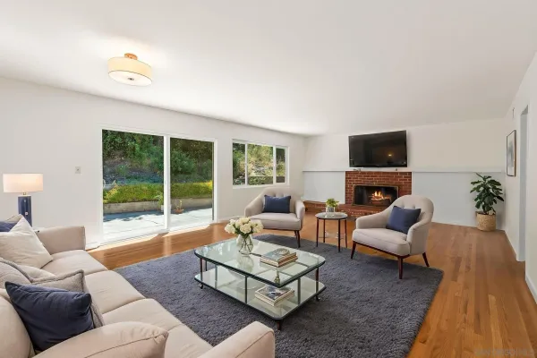 a living room with furniture fireplace and a flat screen tv