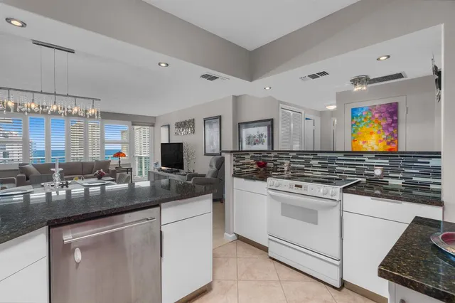 a kitchen with stainless steel appliances granite countertop a sink stove and cabinets