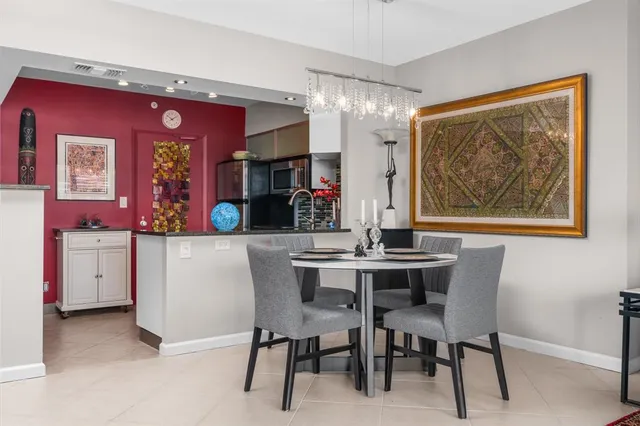 a kitchen with stainless steel appliances granite countertop a stove top oven a sink and a microwave