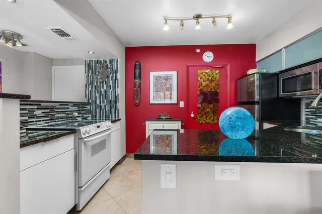 a view of a dining room with furniture and a chandelier