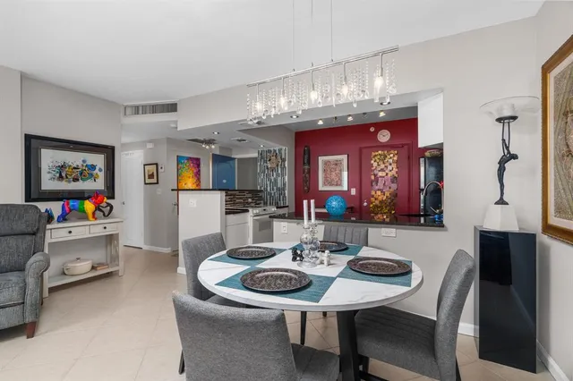 a living room with furniture and a dining table