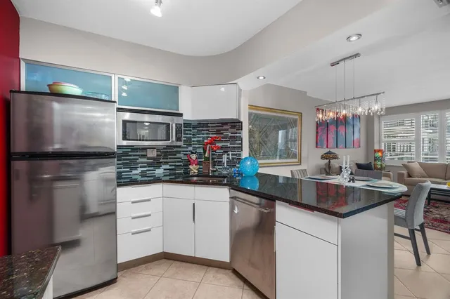 a kitchen with stainless steel appliances a sink stove and refrigerator