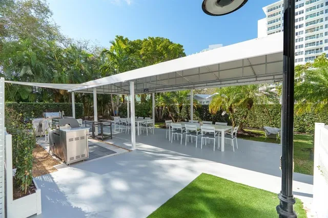 a dining area with a table and chairs