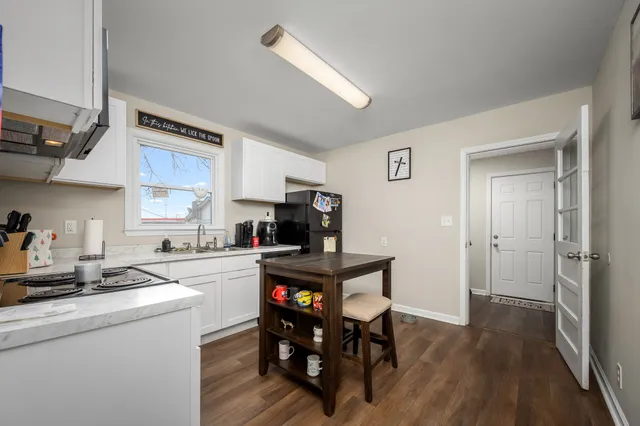 a kitchen with stainless steel appliances granite countertop a sink stove and cabinets