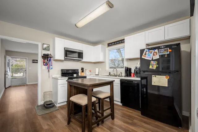 a kitchen with stainless steel appliances a sink a stove top oven a counter space and cabinets