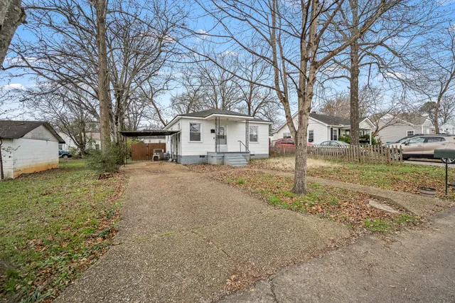 a view of a house with a yard covered in snow