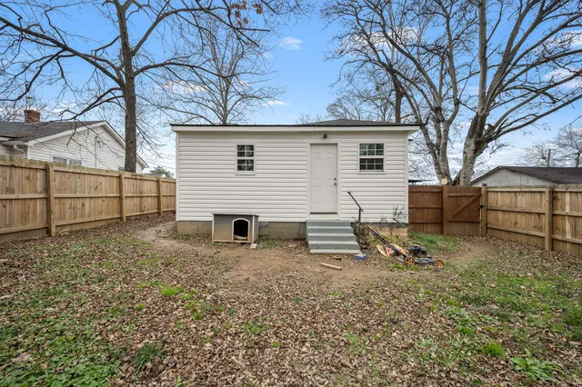 a white house that has a tree in front of it
