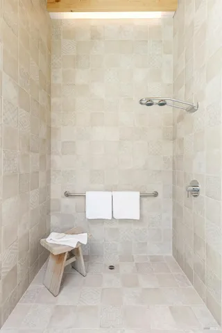 a white toilet sitting next to a shower