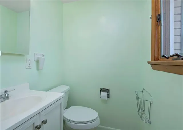 a bathroom with a sink a toilet and mirror