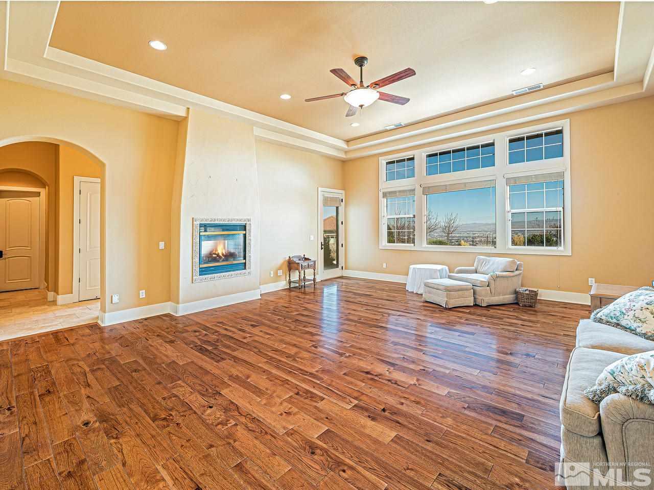 3644 Silver Vista Drive Reno, NV 89511 - Photo 12 of 40 a living room with couches and dining table with wooden floor