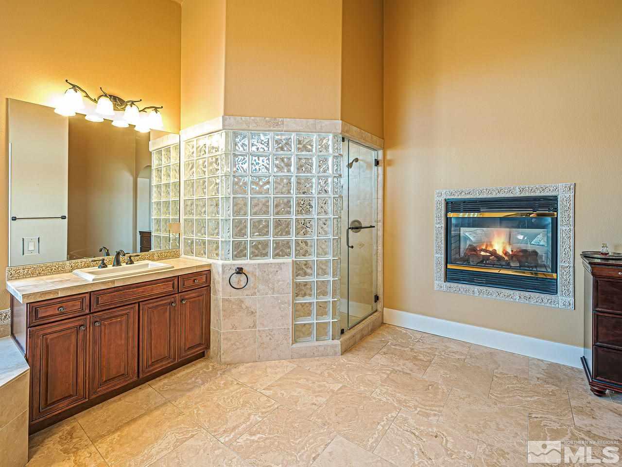 3644 Silver Vista Drive Reno, NV 89511 - Photo 16 of 40 a view of a bathroom with a tub sink shower and mirror
