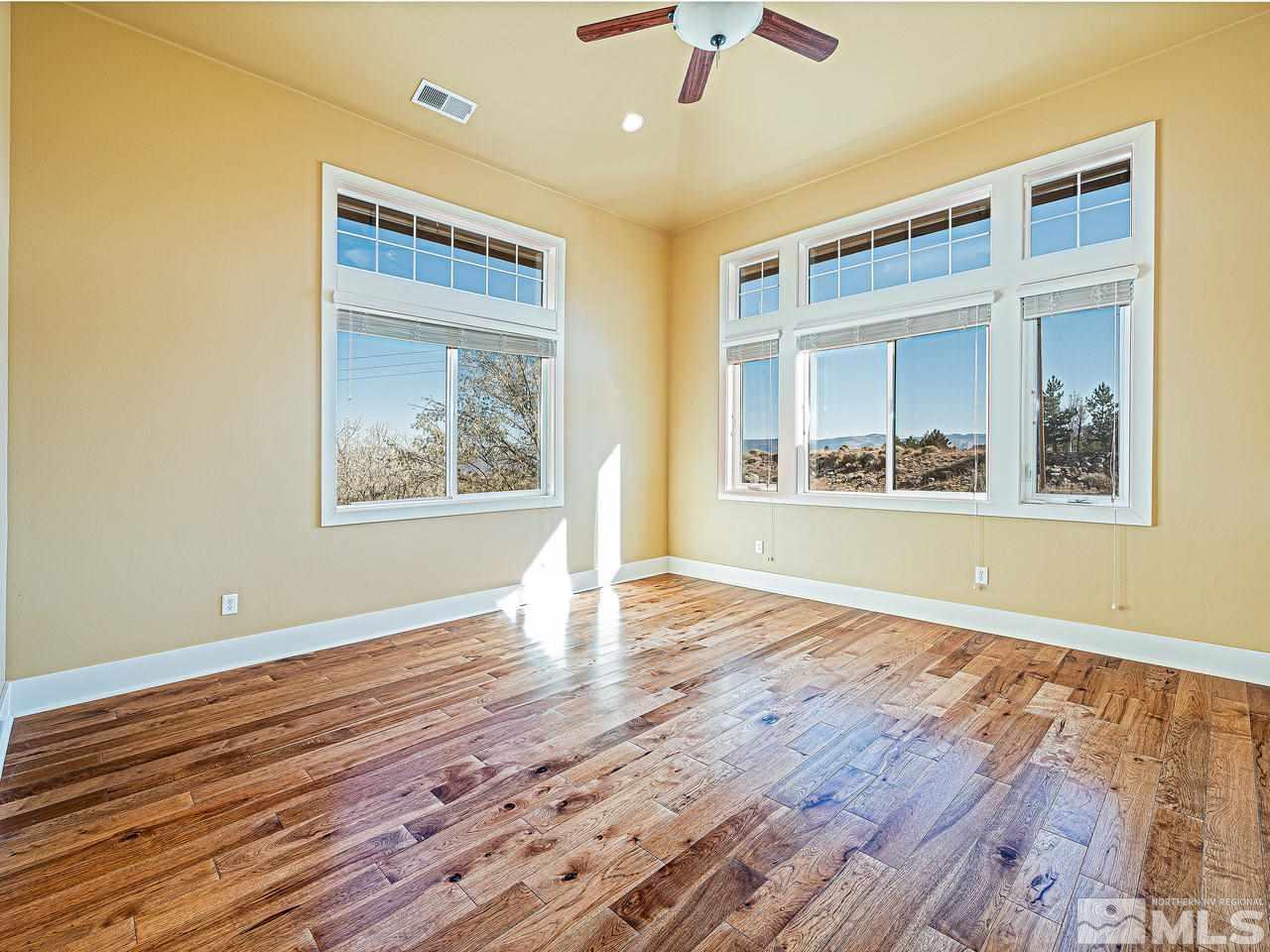 3644 Silver Vista Drive Reno, NV 89511 - Photo 19 of 40 a view of an empty room with wooden floor and a window