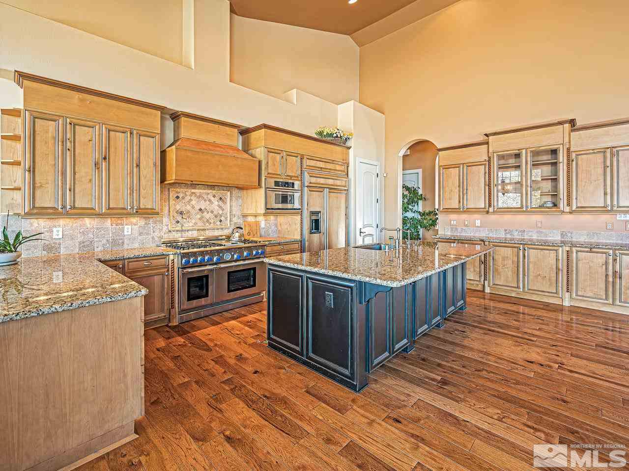 3644 Silver Vista Drive Reno, NV 89511 - Photo 9 of 40 a kitchen with stainless steel appliances granite countertop a stove a sink and a microwave