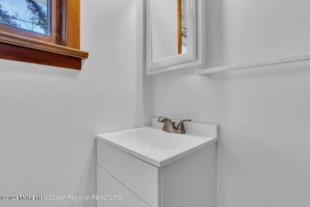 a bathroom with a sink and vanity