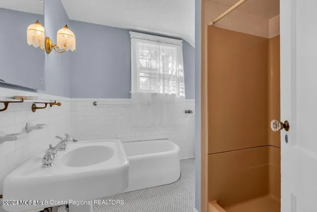 a bathroom with a sink a window and a mirror