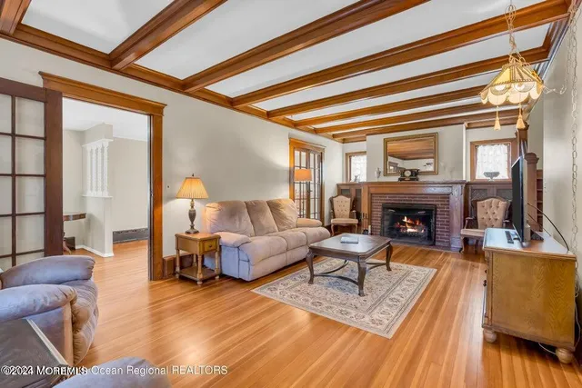 a living room with furniture a fireplace and a table