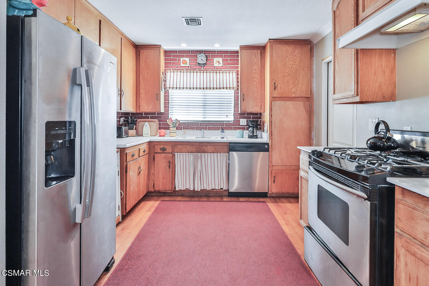 2248 Cutler Street Simi Valley, CA 93065 - Photo 15 of 41 a kitchen with stainless steel appliances granite countertop a refrigerator and a stove