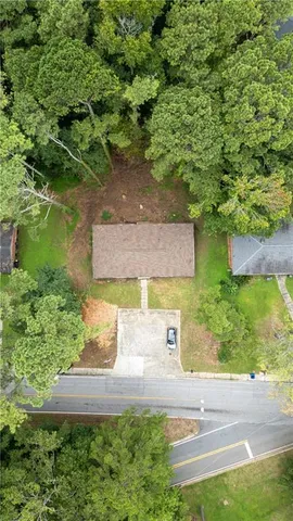an aerial view of a house with garden space and a yard