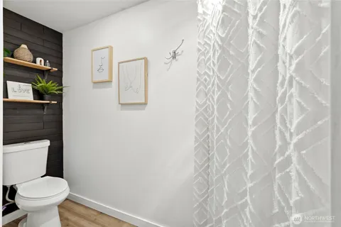 a white toilet sitting next to a white wall