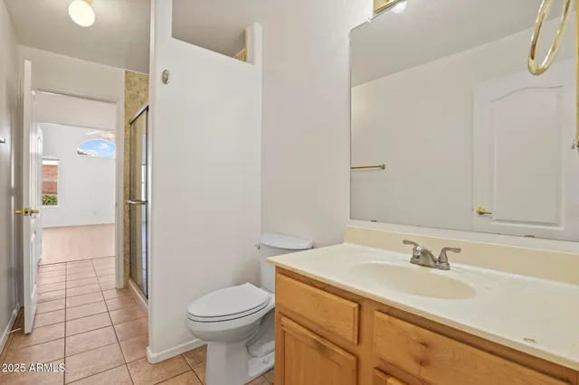 an empty room with a window and a ceiling fan